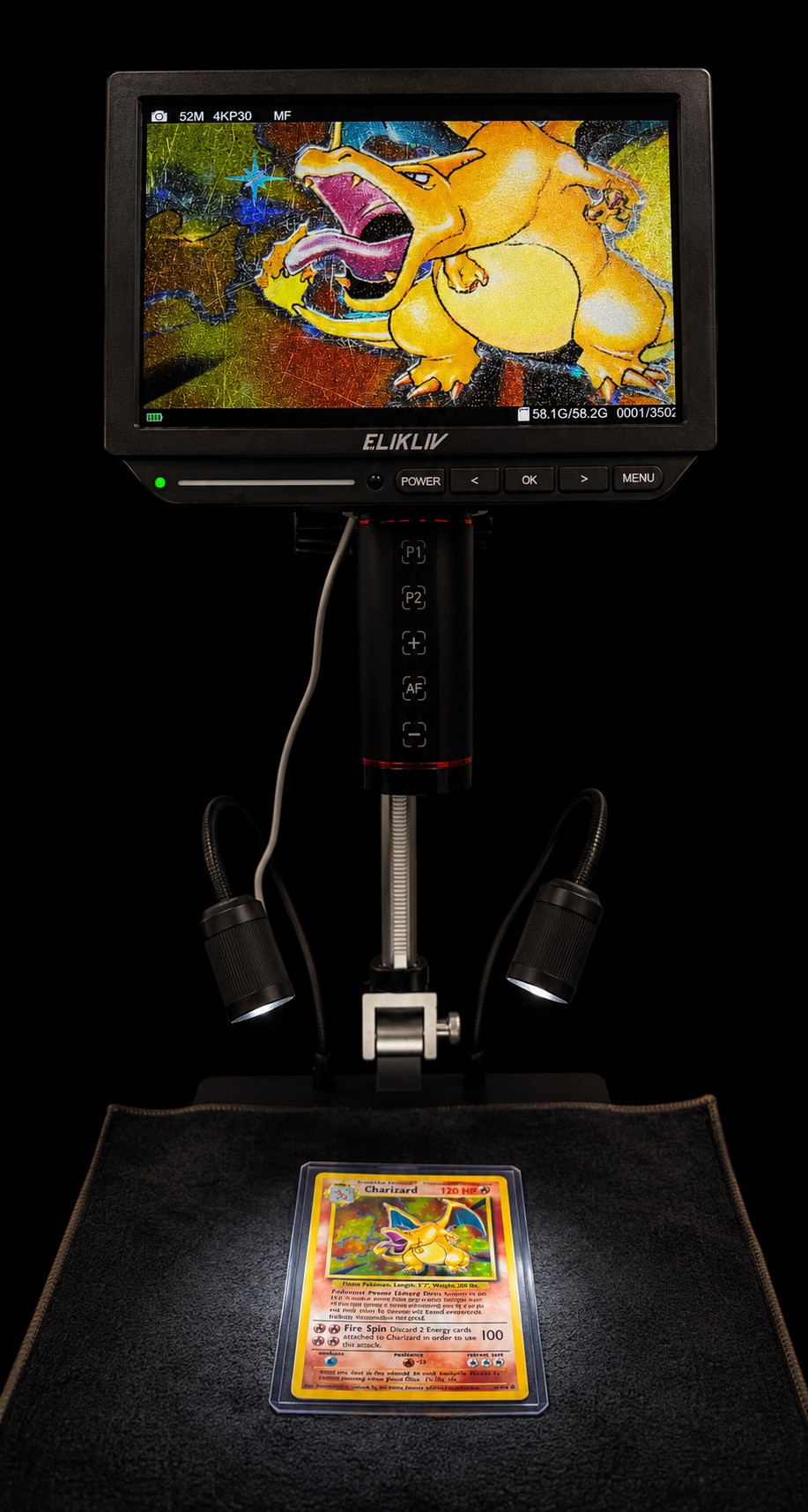 A trading card examined under a high-magnification digital microscope, its surface detail shown on the monitor above