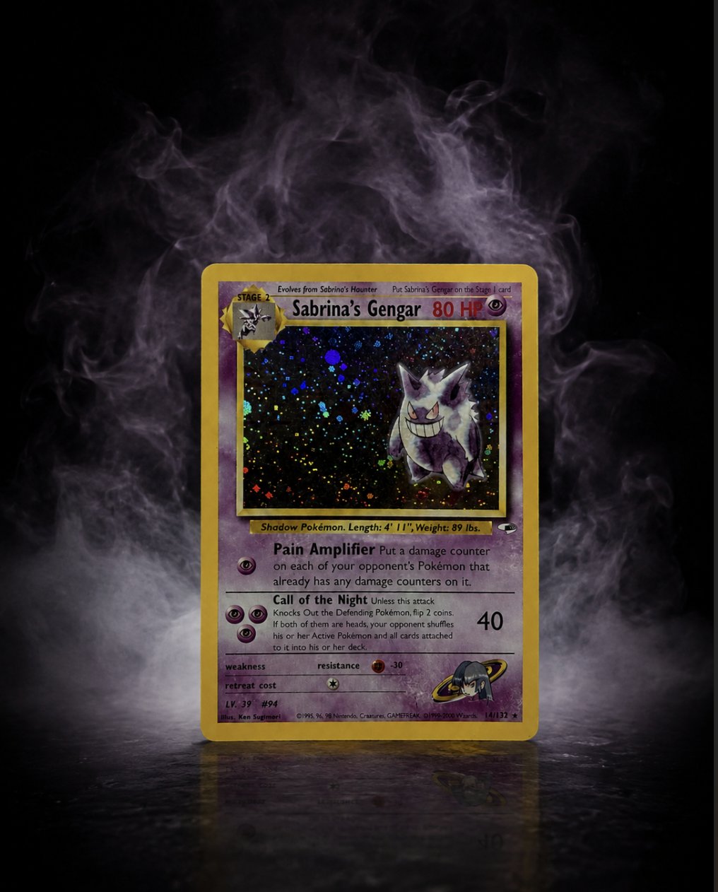 A restored holographic Sabrina's Gengar trading card displayed upright, lit dramatically against a smoky black background