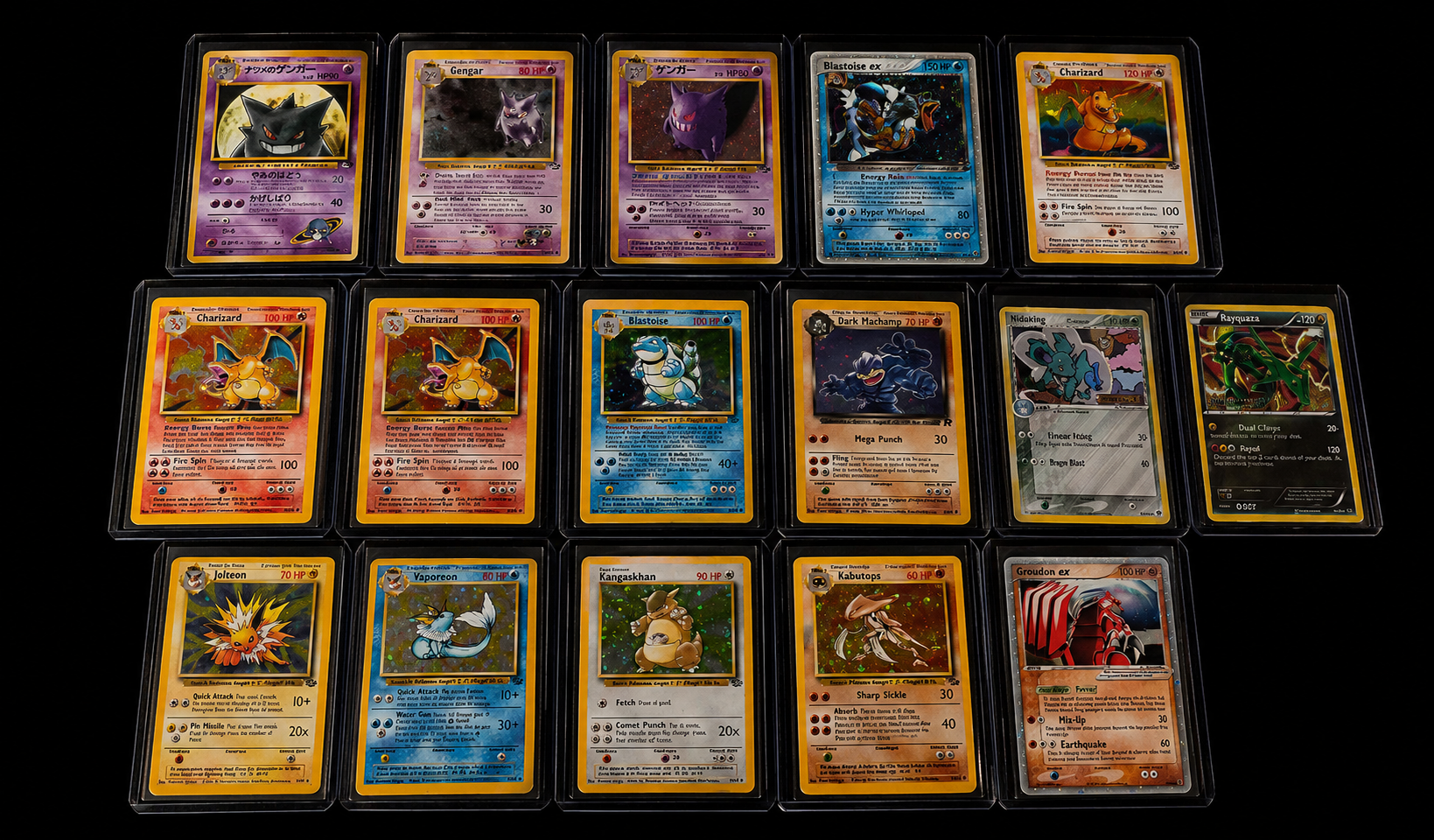 A collection of graded vintage trading cards arranged on a black surface
